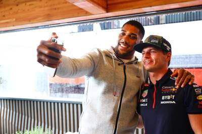 ZANDVOORT, NETHERLANDS - AUGUST 24: Max Verstappen of the Netherlands and Oracle Red Bull Racing meets Anthony Joshua in the Paddock during previews ahead of the F1 Grand Prix of The Netherlands at Circuit Zandvoort on August 24, 2023 in Zandvoort, Netherlands. (Photo by Mark Thompson / Getty Images)