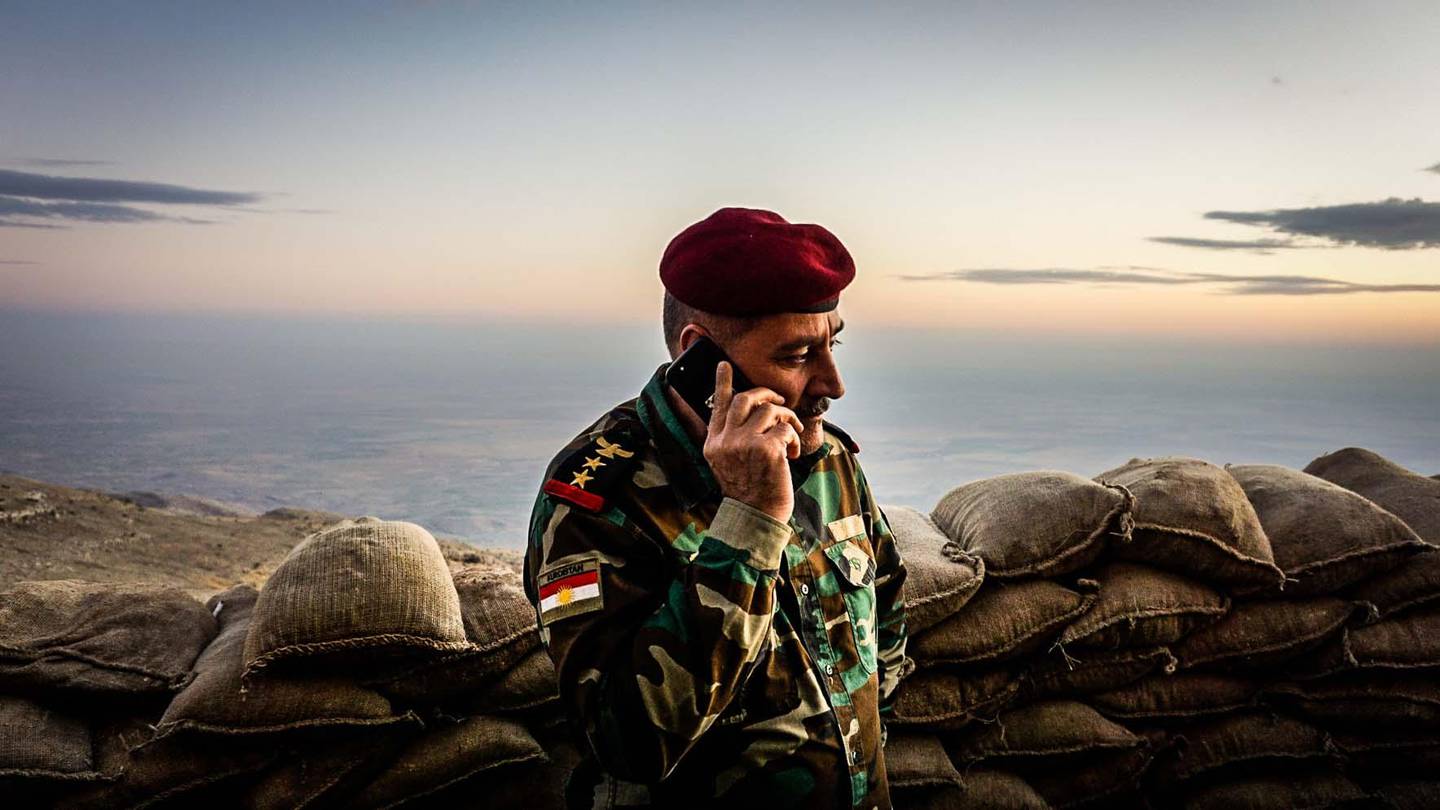 Staff Colonel Srud Barzanji, who heads the Peshmerga’s 46th Division, on the phone at an outpost in the Qara Chokh mountains. Jack Moore / The National
