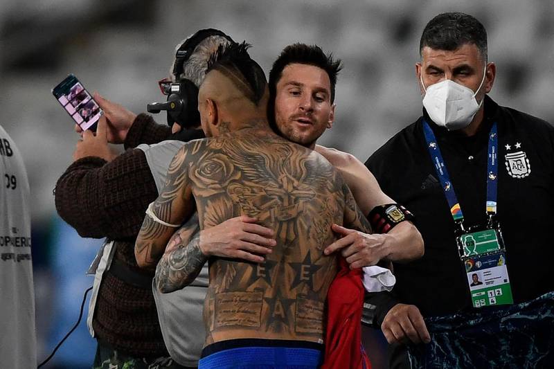 Argentina's Lionel Messi and Chile's Arturo Vidal embrace at the end of the match, that ended 1-1. AFP