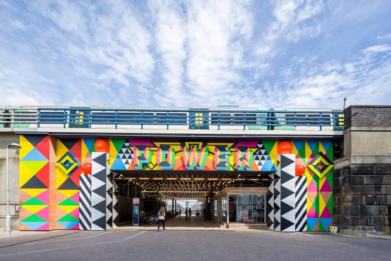 The entrance to Circus West Village with artwork by Morag Myerscough.
