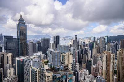 A general view shows residential and commercial buildings on Hong Kong island (foreground) and Kowloon (background) separated by Victoria Harbour in Hong Kong on May 11, 2021. (Photo by Anthony WALLACE / AFP)