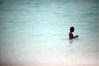 (Abu Dhabi, UAE- July 22, 2012|) Ahmed Abdullah, 12, has the Corniche Beach mostly all to himself as he braves the 45c Degree heat in Abu Dhabi July 22, 2012. (Sammy Dallal / The National)