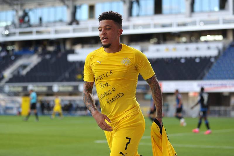 Dortmund's English midfielder Jadon Sancho shows a 'Justice for George Floyd' shirt as he celebrates after scoring his team's second goal during at Paderborn. AFP