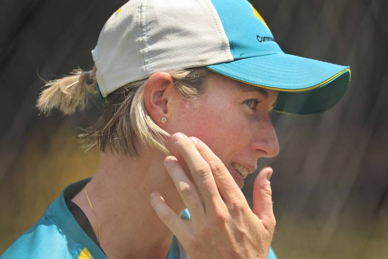 Australia's Beth Mooney shows where she fractured her jaw during a women's Ashes training session at the Manuka Oval. Getty