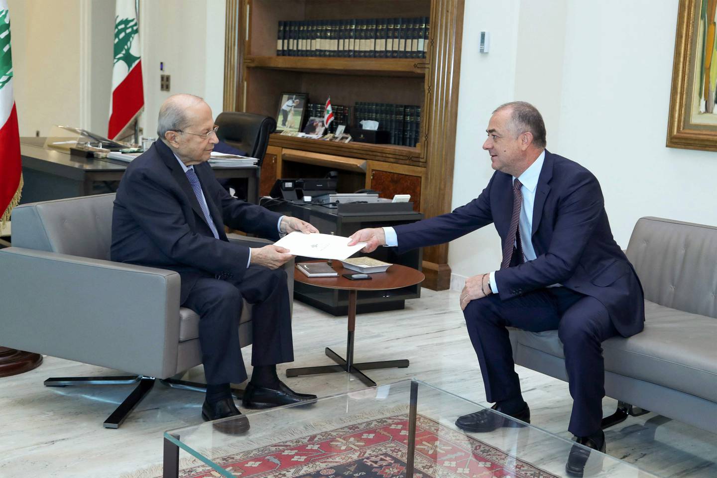 Lebanon's senior negotiator, Elias Bou Saab, hands the latest draft of a US-mediated proposal to demarcate Lebanon's maritime border with Israel to President Michel Aoun. AFP