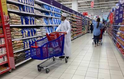 Shoppers check rice products at the Carrefour hypermarket at Mall of the Emirates in Dubai. Pawan Singh / The National 