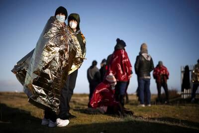Migrants on the beach at Dungeness, after crossing the English Channel in an inflatable dinghy in January. Reuters