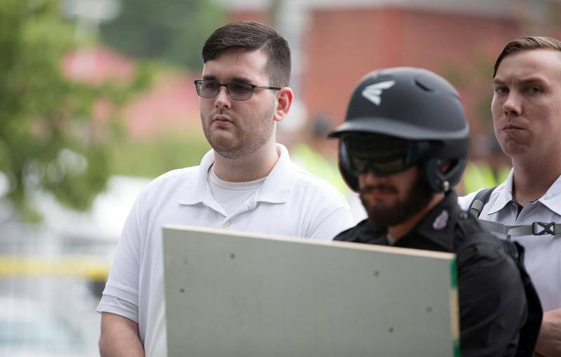 FILE PHOTO: James Alex Fields Jr., (L) is seen attending the "Unite the Right" rally in Emancipation Park before being arrested by police and charged with charged with one count of second degree murder, three counts of malicious wounding and one count of failing to stop at an accident that resulted in a death after police say he drove a car into a crowd of counter-protesters later in the afternoon in Charlottesville, Virginia, U.S., August 12, 2017. REUTERS/Eze Amos/File Photo