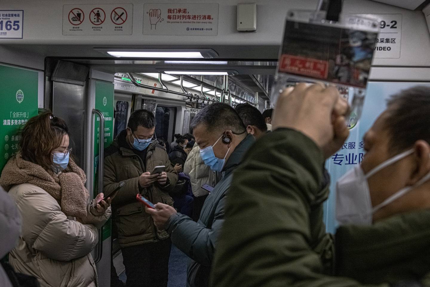 Passengers ride a subway in Beijing. EPA