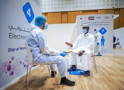 Abu Dhabi, United Arab Emirates, June 4, 2020.     A patient is interviewed by a healthcare worker at he new Covid-19 Prime Assessment Center at ADNEC.Victor Besa  / The NationalSection:  NAReporter:  Shireena Al Nowais