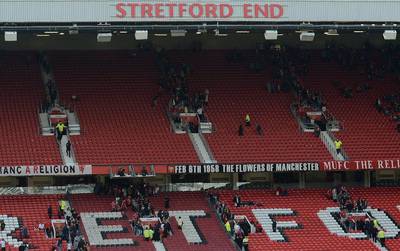 Fans leave the the Stretford End and the Sir Alex Ferguson Stand (unseen) following an evacuation of both stands on Sunday. Oli Scarff / AFP / May 15, 2016 