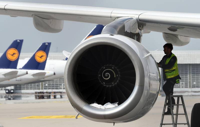 (FILES) This file photo taken on April 28, 2020 shows a technician of the German airline Lufthansa working at a parked plane at the "Franz-Josef-Strauss" airport in Munich, southern Germany.  German airline Lufthansa is to cut 22,000 jobs due to the effects of the coronavirus pandemic, a spokesman said on June 11, 2020. / AFP / Christof STACHE
