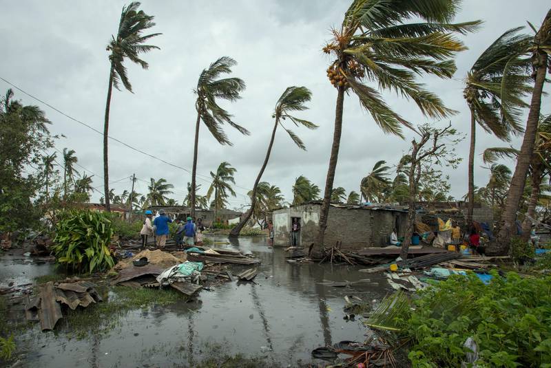 People return to their homes following a cyclone, and heavy rain in the coastal city of Beira, Mozambique, Sunday March 17, 2019.  More than 1,000 people are feared dead in Mozambique four days after a cyclone slammed into the southern African country destroying vulnerable residential areas. (Josh Estey/CARE via AP)