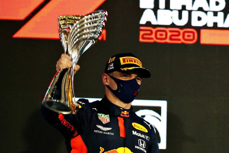 ABU DHABI, UNITED ARAB EMIRATES - DECEMBER 13: Race winner Max Verstappen of Netherlands and Red Bull Racing celebrates on the podium during the F1 Grand Prix of Abu Dhabi at Yas Marina Circuit on December 13, 2020 in Abu Dhabi, United Arab Emirates. (Photo by Mark Thompson/Getty Images)