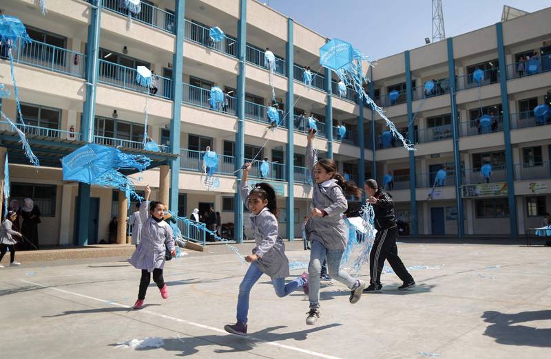 Palestinian schoolgirls fly kites outside their classrooms at a school belonging to the United Nations Relief and Works Agency for Palestinian Refugees (UNRWA) in Gaza City on March 12, 2018 as a protest against US aid cuts.
On January 16, Washington held back $65 million that had been earmarked for the UN Relief and Works Agency for Palestinian refugees (UNRWA), but the State Department denied the freeze was to punish the Palestinian leadership, which has cut ties with President Donald Trump's administration following his recognition of Jerusalem as Israel's capital last year, with a spokeswoman saying it was linked to necessary "reform" of UNRWA. / AFP PHOTO / MAHMUD HAMS