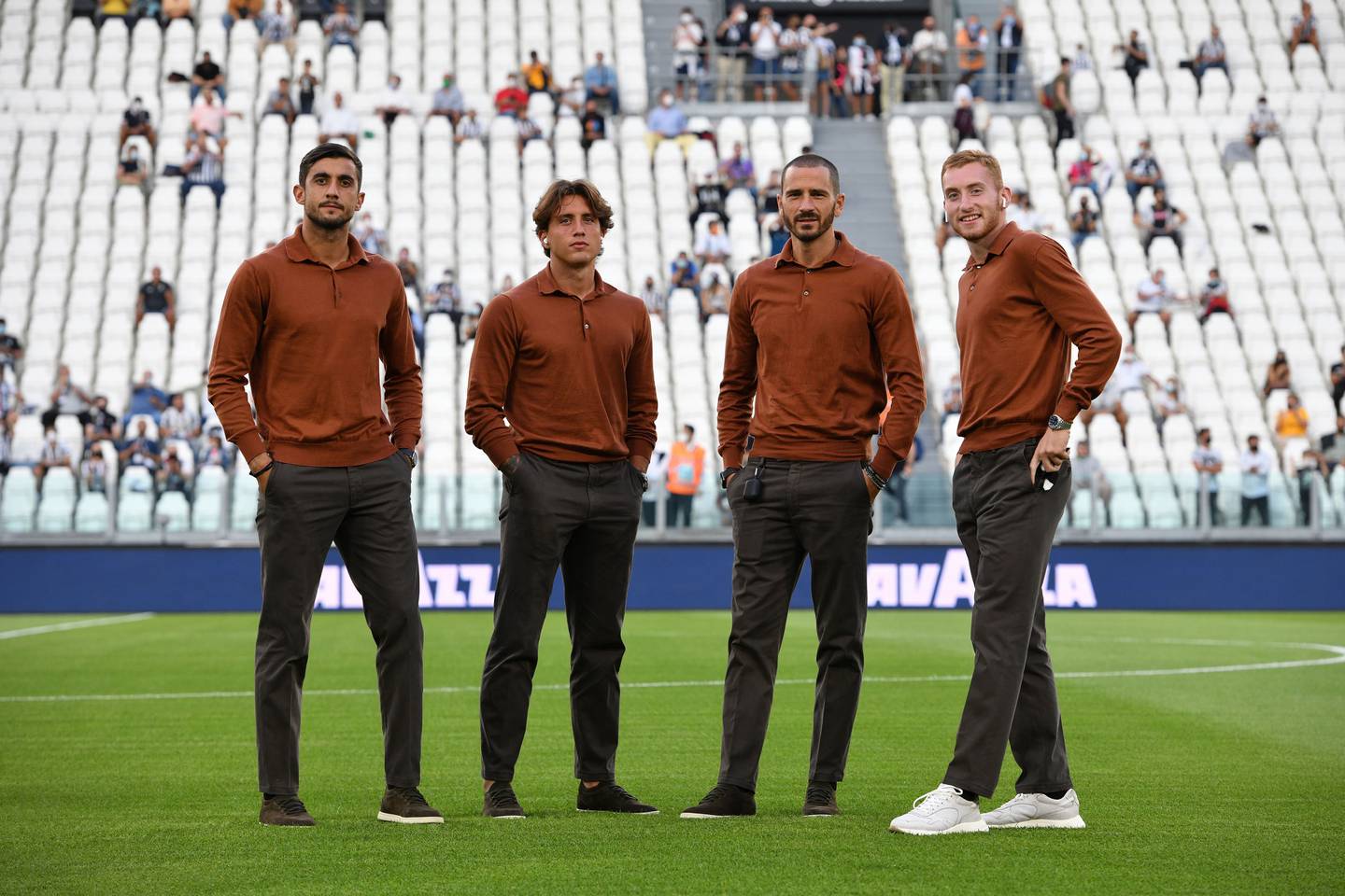 Wearing the new kit by Loro Piana, Juventus players Mattia Perin, Luca Pellegrini, Leonardo Bonucci and Dejan Kulusevski stand on the pitch in Turin, Italy. Photo: Juventus FC