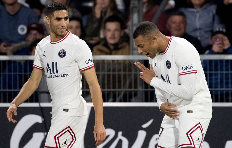 Paris Saint-Germain forward Kylian Mbappe celebrates with  Achraf Hakimi after scoring the first goal against Angers. AFP