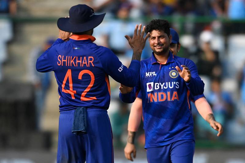 India's Kuldeep Yadav (R) celebrates with captain Shikhar Dhawan after taking the wicket of South Africa's Anrich Nortje (not pictured) during the third and final one-day international (ODI) cricket match between India and South Africa at the Arun Jaitley Stadium in New Delhi on October 11, 2022.  (Photo by Sajjad HUSSAIN  /  AFP)  /  ----IMAGE RESTRICTED TO EDITORIAL USE - STRICTLY NO COMMERCIAL USE-----