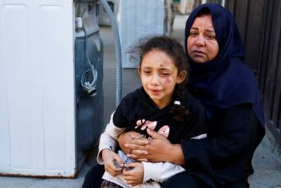 A Palestinian girl following an Israeli air strike in Khan Younis. Reuters