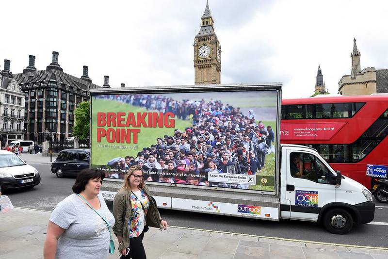 Pedestrians walk past by the poster launched by the British UKIP leader Nigel Farage for the Vote Leave campaign. Facundo Arrizabalaga / EPA