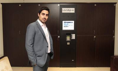 Bader Al Kalooti, the founder of Laundrybo, with his automated locker system, which lets tenants drop off and pick up their laundry at their convenience.  Jeffrey E Biteng / The National