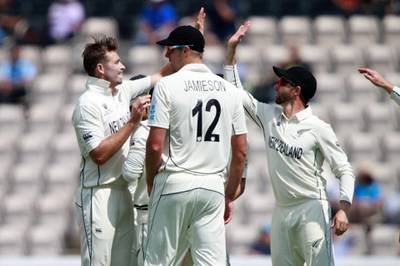 New Zealand's Tim Southee, left, celebrates with teammates the dismissal of India's Mohammed Shami. AP