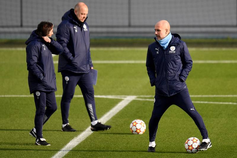 Manchester City manager Pep Guardiola juggles the ball during training for the Sporting match. AFP