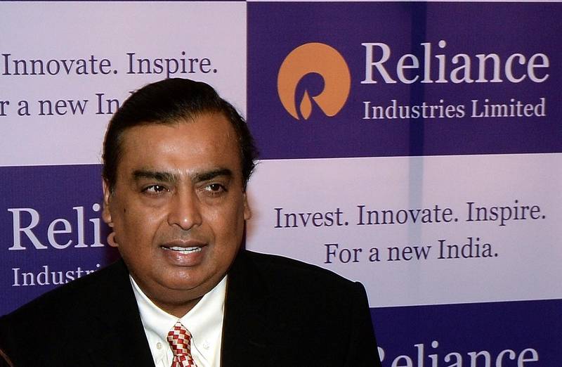 Reliance Industries chairman, Mukesh Ambani poses on his arrival for the company's annual general meeting in Mumbai on June 12, 2015.  Reliance Industries is holding its 41st annual general shareholders meeting.  AFP PHOTO/ PUNIT PARANJPE (Photo by PUNIT PARANJPE / AFP)