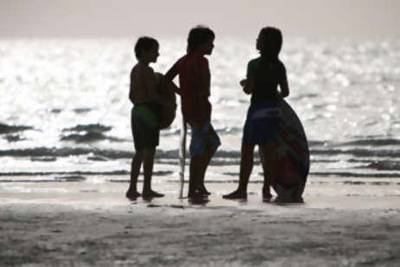 Children on Jumeirah public beach in Dubai.