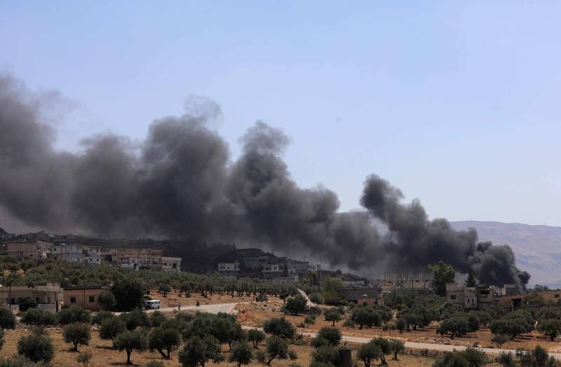 A picture taken on September 4, 2018 shows smoke blowing from buildings on fire that were hit by reported Russian air strikes in the rebel-hold town of Muhambal, about 30 kilometres southwest of the city of Idlib.???? ????? - Russian warplanes battered Syria's rebel-controlled northwestern Idlib province on September 4 for the first time in three weeks, the Syrian Observatory for Human Rights reported, as fears of a government offensive mount. (Photo by OMAR HAJ KADOUR / AFP)