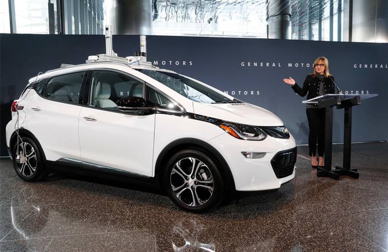 FILE - In this Dec. 15, 2016, file photo, General Motors Chairman and CEO Mary Barra speaks next to a autonomous Chevrolet Bolt electric car in Detroit. The jobs that GM will shed through buyouts and layoffs are now held by people who are experts in the internal combustion engine, mechanical engineers and managers who work on complex components that wonâ€™t be needed on the much simpler electric vehicles that the largest U.S. automaker says are its future. GM said cutting these jobs is necessary to invest self-driving and other new technologies. (AP Photo/Paul Sancya, File)