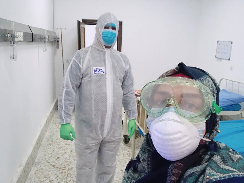 Farah Al-Awadi, a 28-year-old Iraqi woman who has contracted coronavirus disease, takes selfies with a member of the medical team during quarantine in the holy city of Najaf, Iraq. Reuters