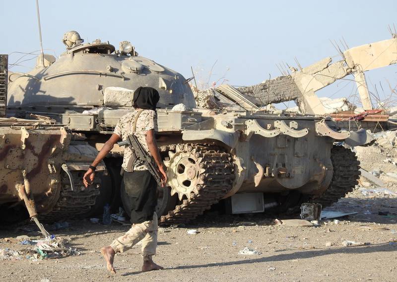 epa07262145 A Yemeni pro-government soldier walks past tanks at a position during a ceasefire in the port city of Hodeidah, Yemen, 04 January 2019. According to reports, UN envoy for Yemen Martin Griffiths will travel to the Yemeni capital Sanaâ€™a and the Saudi capital Riyadh in the coming days to hold a new round of talks with Houthi rebels and the Saudi-backed Yemeni government as the cessation in Hodeidah continues to hold.  EPA/NAJEEB ALMAHBOOBI