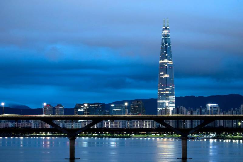The Lotte Corp. World Tower, right, and other buildings stand illuminated at dawn in Seoul, South Korea, on Friday, Aug. 11, 2017. South Korea'sÂ stocks and currencyÂ fell after President Donald Trump warned North Korea that if it "does anything" to the U.S. or its allies "things will happen to them like they never thought possible." Photographer: SeongJoon Cho/Bloomberg via Getty Images