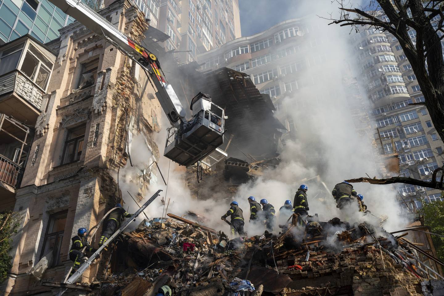 Firefighters work after a drone attack on buildings in Kyiv on October 17. AP
