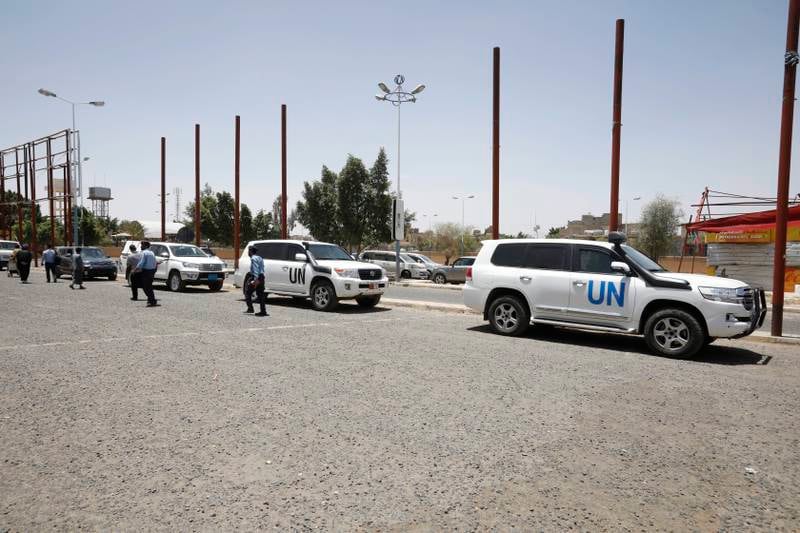 Pro-Houthi soldiers pass UN vehicles parked at Sanaa airport on June 8. Photo: EPA