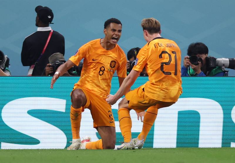Cody Gakpo celebrates scoring the Netherlands' first goal against Senegal with Frenkie de Jong. Reuters