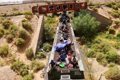 Migrants travel on a train through Ciudad Juarez, Mexico, with the intention of reaching the US. Reuters