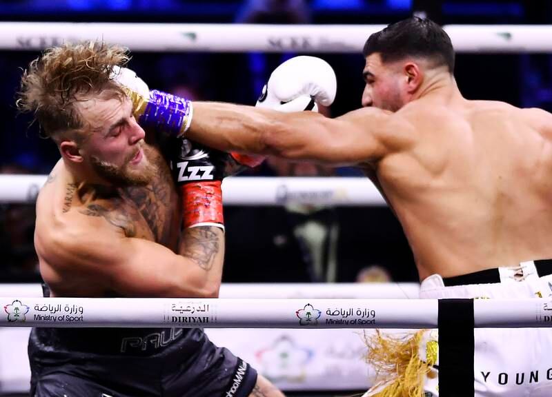 Tommy Fury, right, punches Jake Paul. EPA