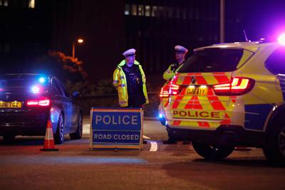 Police officers and their vehicles close off a road after reported multiple stabbings in Reading. REUTERS