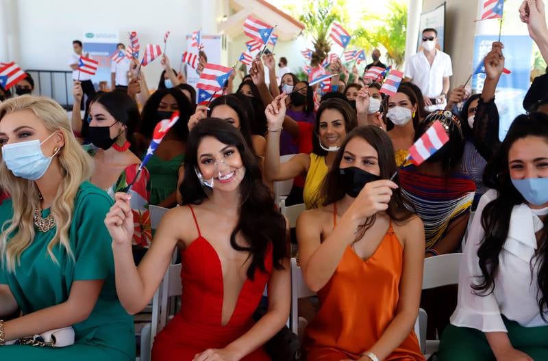 Miss World 2021 contestants wave the Puerto Rican flag at the Coliseo de Puerto Rico.