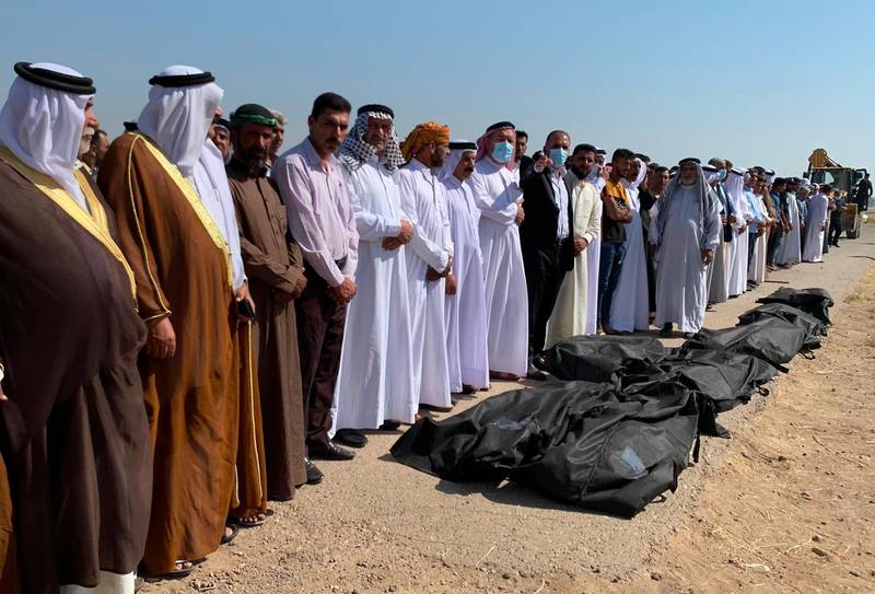 Sunni Muslim men pray over the bodies of eight out of 12 fellow Iraqis, who were reportedly kidnapped on October 17 and later some of them found shot dead, during their burial ceremony in the Farhatiya area of the Balad region, located 70 kilometres (around 45 miles) north of Baghdad in the Salaheddin province, on October 18, 2020.   Local sources said the four other kidnapped men have not been found and the identity of the assailants remains unknown in the mysterious crime. / AFP / -

