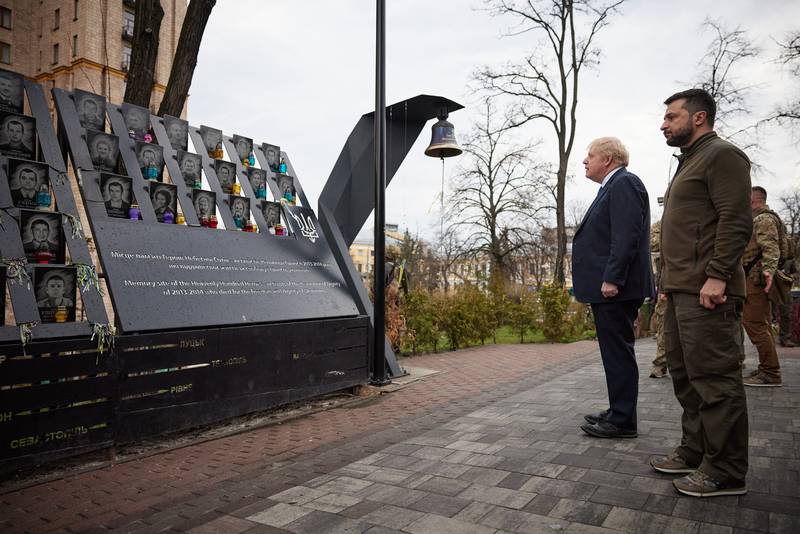 Mr Johnson, left, and Mr Zelenskyy visit the Memorial to the Heavenly Hundred Heroes in Kyiv. AFP