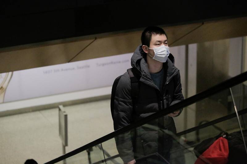 A traveller wearing a mask arrives on a direct flight from China, after a spokesman from the U.S. Centers for Disease Control and Prevention (CDC) said a traveller from China had been the first person in the United States to be diagnosed with the Wuhan coronavirus, at Seattle-Tacoma International Airport in SeaTac, Washington, U.S. January 23, 2020.  REUTERS/David Ryder