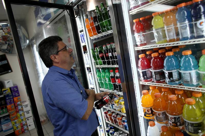 MIAMI, FL - DECEMBER 09: Gilberto Flores stocks the shelf with Diet Coke at the Amerika convience store on December 9, 2013 in Miami, Florida. According to reports, sales of diet sodas dropped 6.8 percent through November 23, 2013, making the contraction in sales of diet soda more than regular soda for three straight years.   Joe Raedle/Getty Images/AFP
