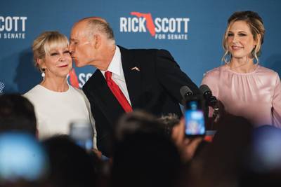 Senator-elect Rick Scott, governor of Florida, kisses wife Ann Scott while speaking to attendees during an election night rally in Naples, Florida. Bloomberg