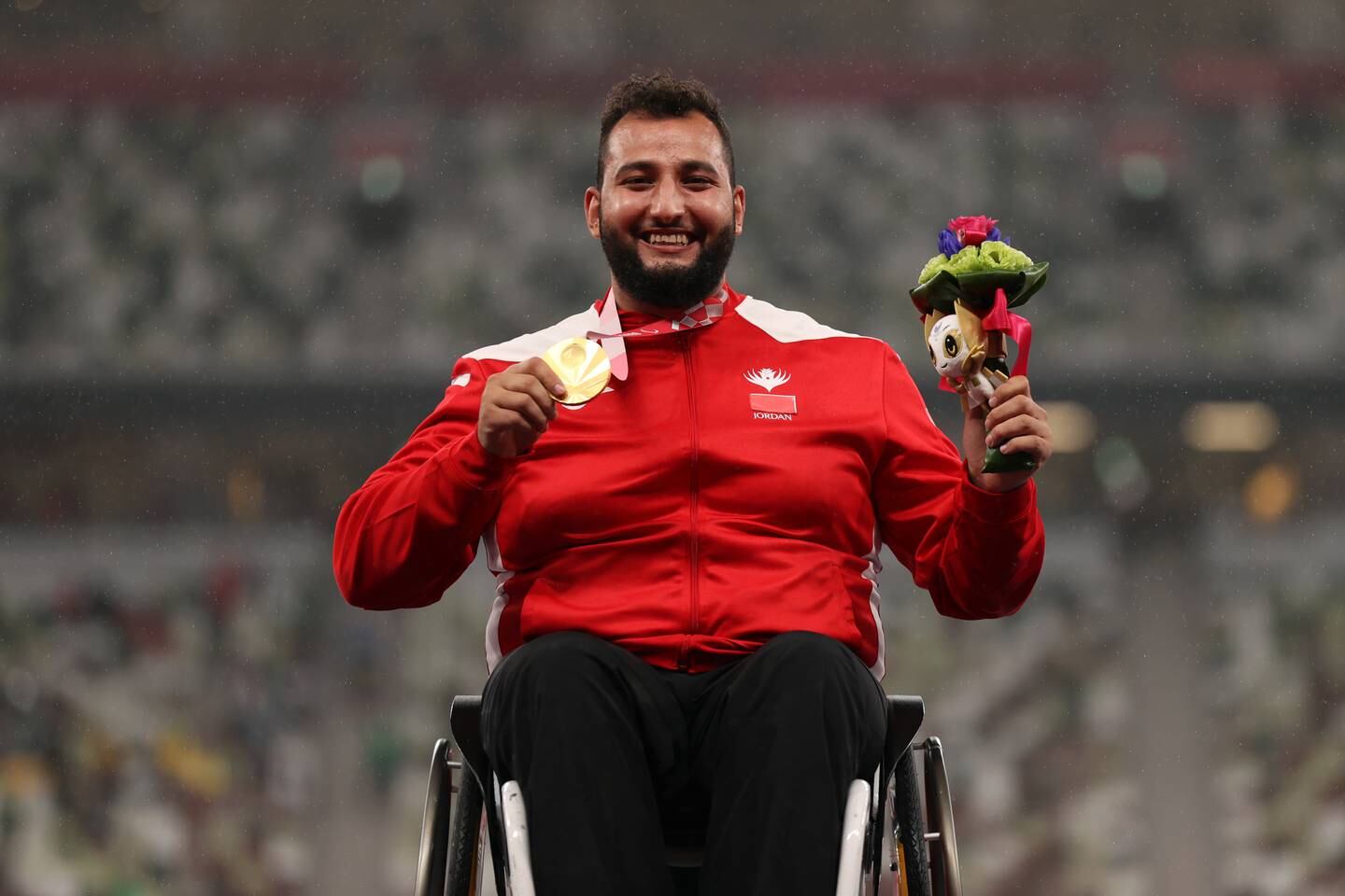Jordan's Ahmad Hindi with his gold medal at the Olympic Stadium in Tokyo. Getty