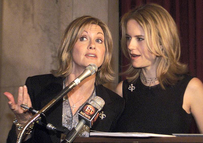 Actress/singer Olivia Newton-John (L) and actress Kelly Preston talk about their new video for the Children's Health Environmental Coalition (CHEC) on Capitol Hill in Washington May 9, 2001. The video promotes awareness of childproofing homes from dangerous environmental toxins.

BM/BK
