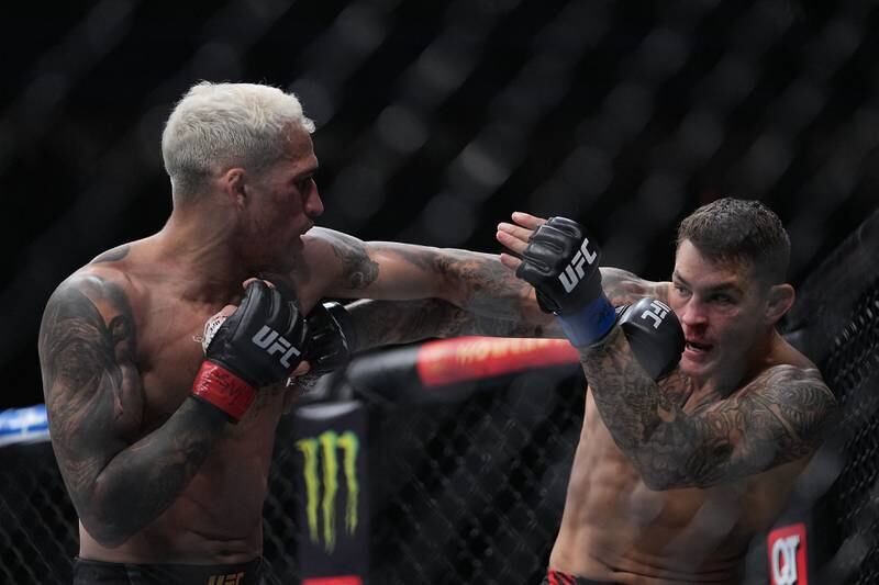 Charles Oliveira, left, moves in with a hit against Dustin Poirier. Reuters