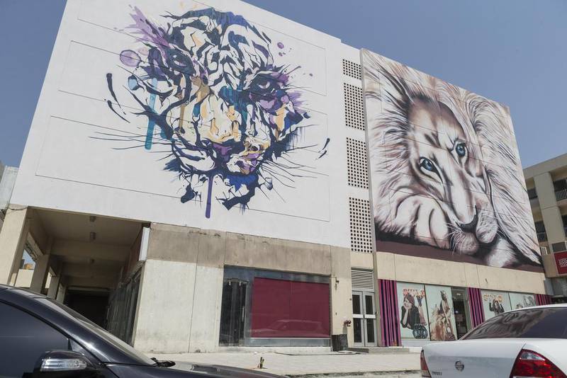 24 murals have been painted on the side of 12 apartment buildings and shops around the Karama shopping complex. Antonie Robertson / The National